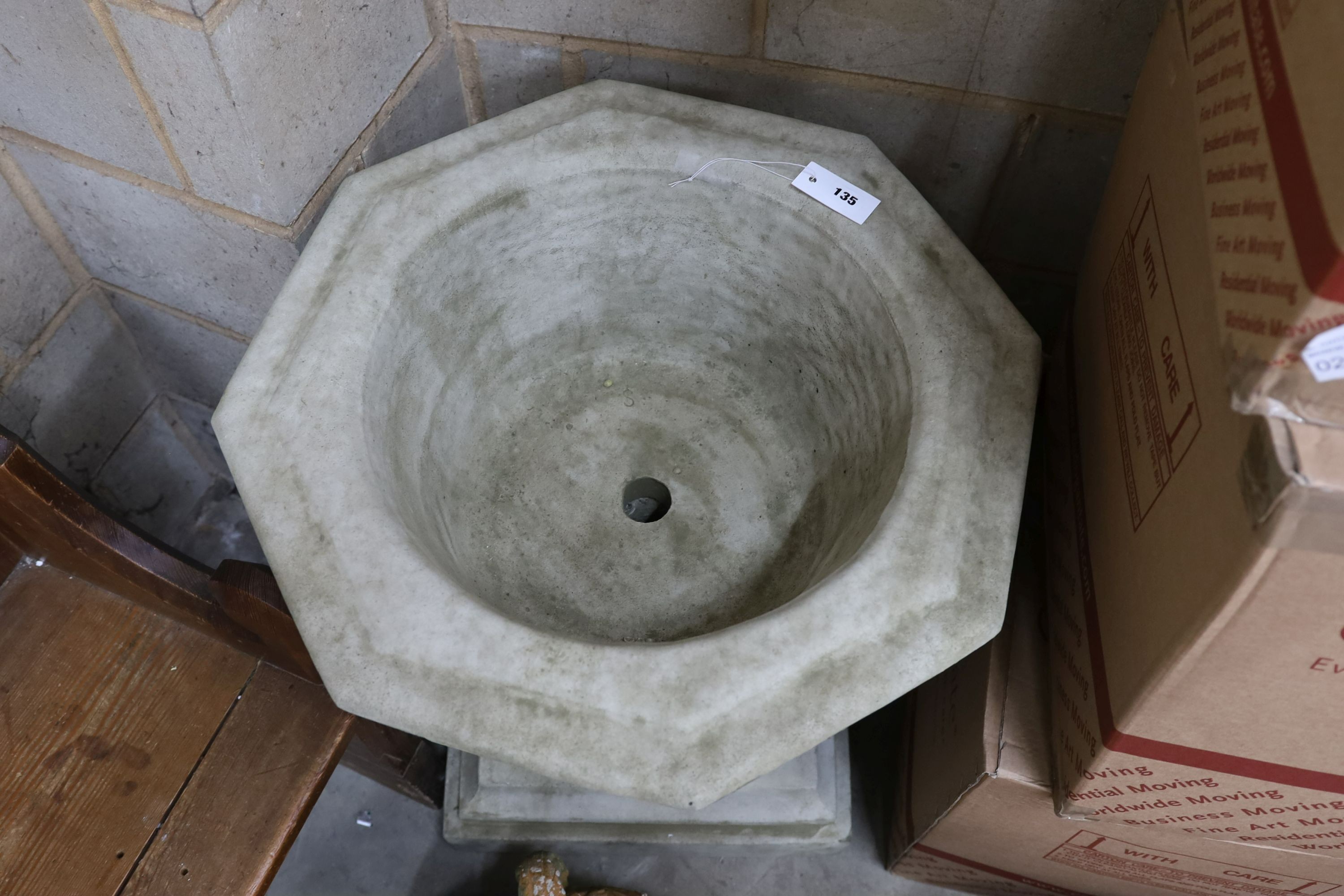 A reconstituted stone octagonal garden 'font' planter, width 60cm, height 74cm